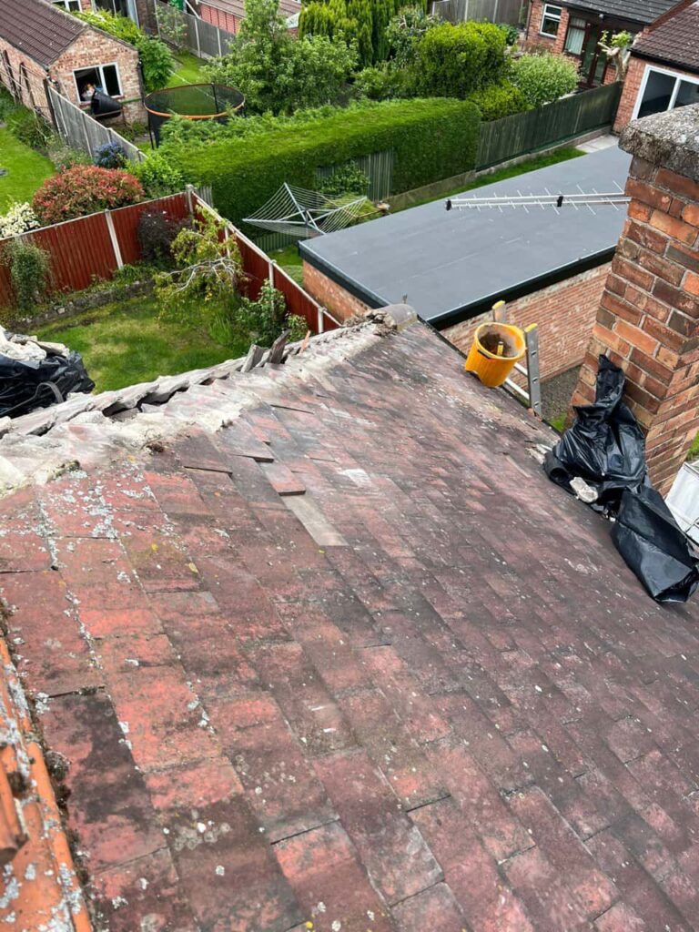 This is a photo of a roof where the hip tiles have been removed, and are just about to be replaced. Works carried out by Gamston Roofing Repairs