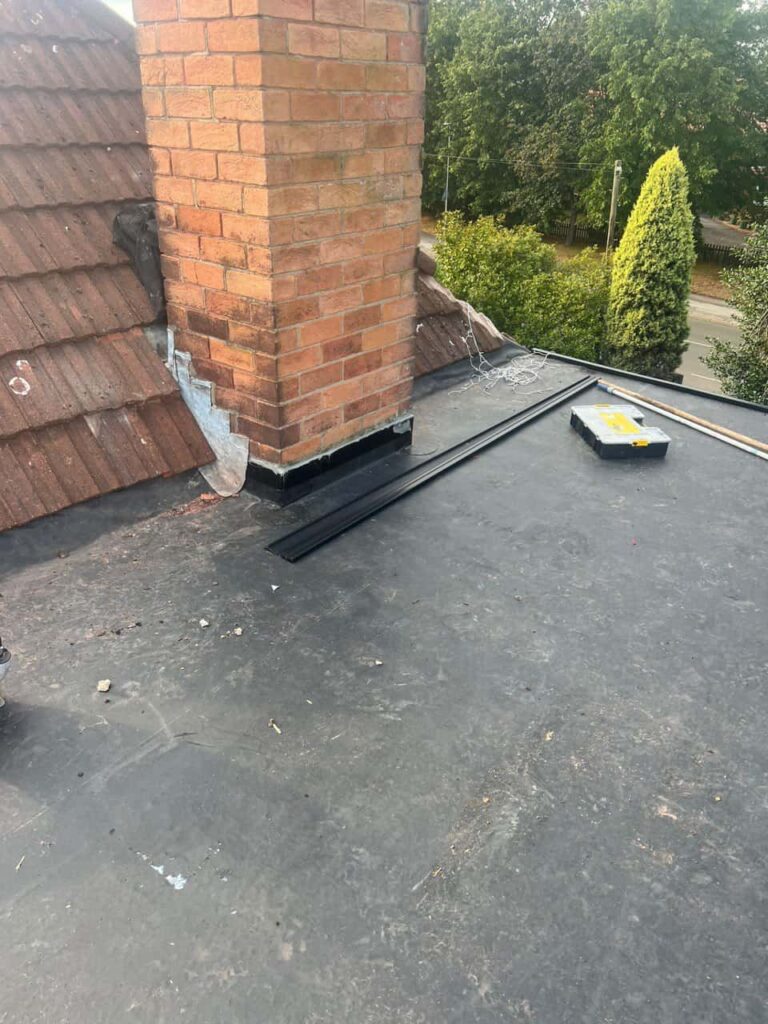 This is a photo of a flat roof which has just been repaired, there is also a chimney stack and some leadwork has also been dressed. Works carried out by Gamston Roofing Repairs